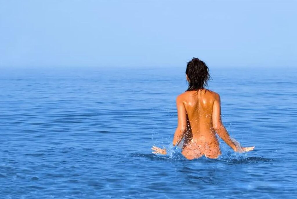 Nudist swimming on a beautiful sea